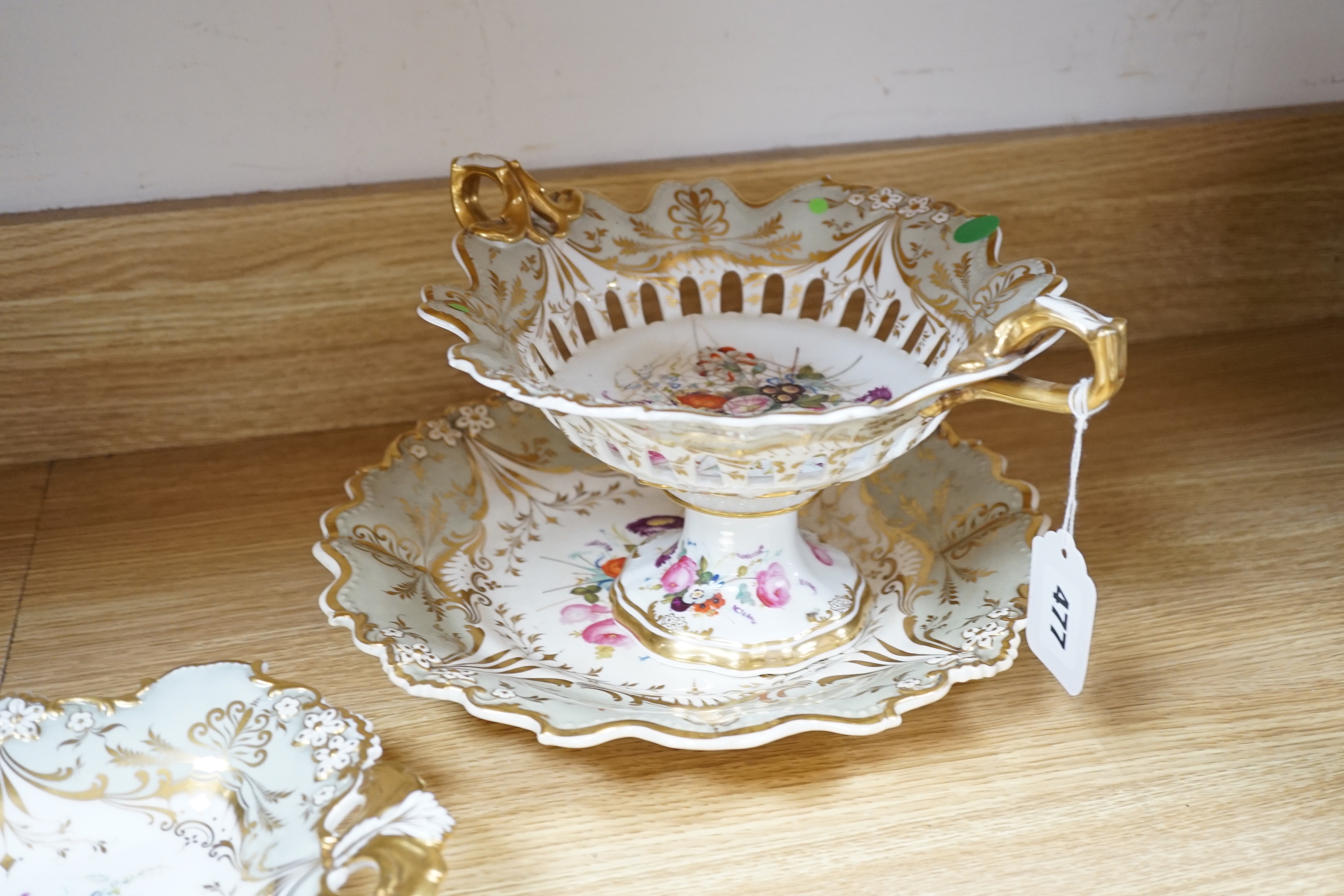 A Davenport porcelain part dessert service, each piece painted with a differing floral bouquet, within shaped grey and gilt borders